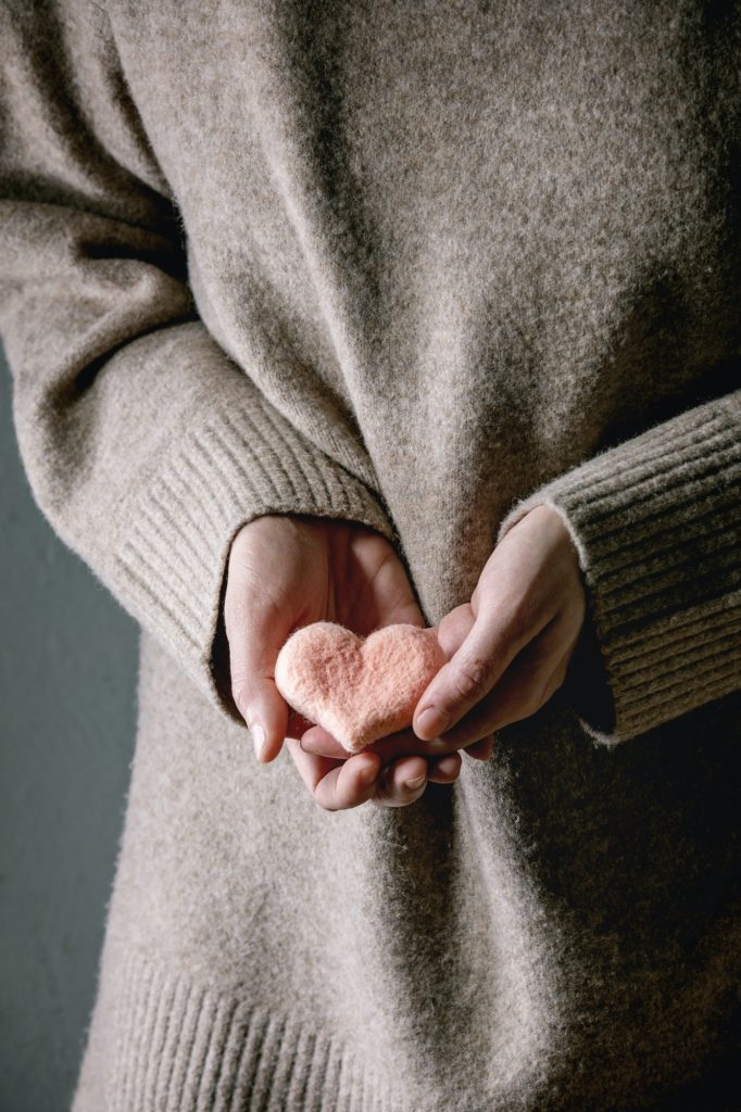 Felted hearts in female hands