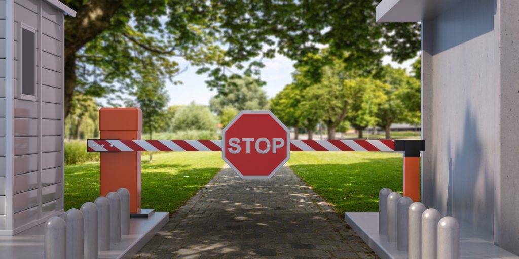 Closed barrier gate and stop sign, green nature background. 3d illustration