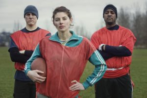 Two men and a woman, members of a team of American flag football players.