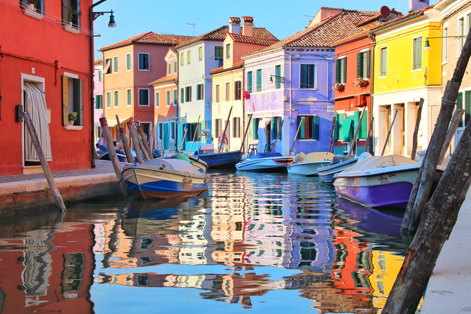 colorful houses reflected in the canal with boats