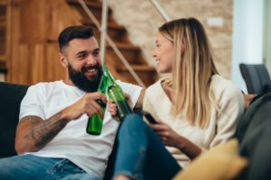 Couple drinking beer at home