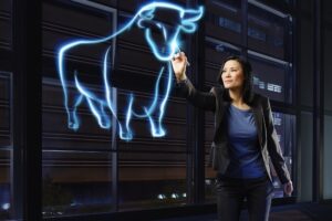 Businesswoman painting a bull with light