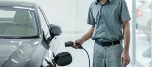 Senior asian Technician is charging the electric car or EV in service center for maintainance,