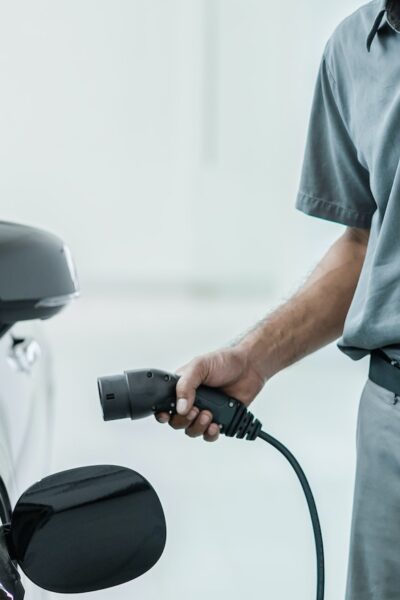 Senior asian Technician is charging the electric car or EV in service center for maintainance,