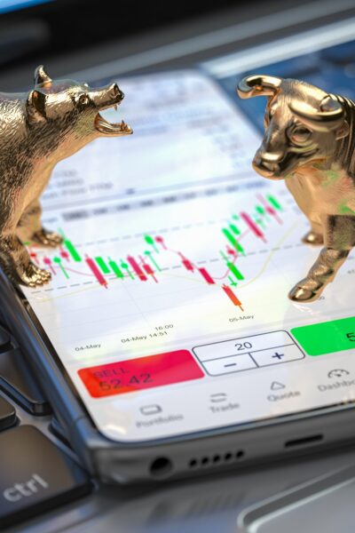 Golden bull and bear as symbols of stock market on a smartphone