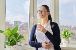 Business woman with glass of water with lemon