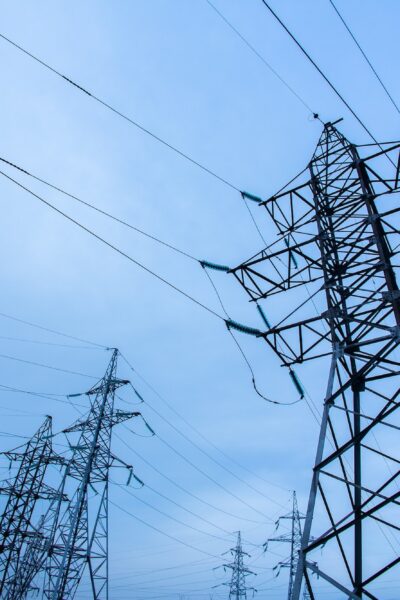 Electricity pylons on blue sky background. Power and energy. Energy conservation