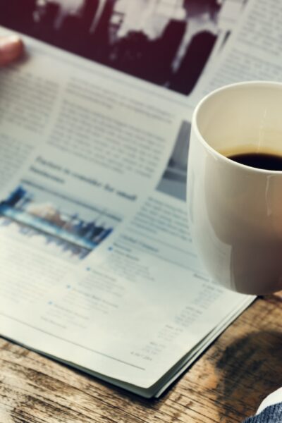 Businessman Reading Newspaper Drinking Coffee Concept