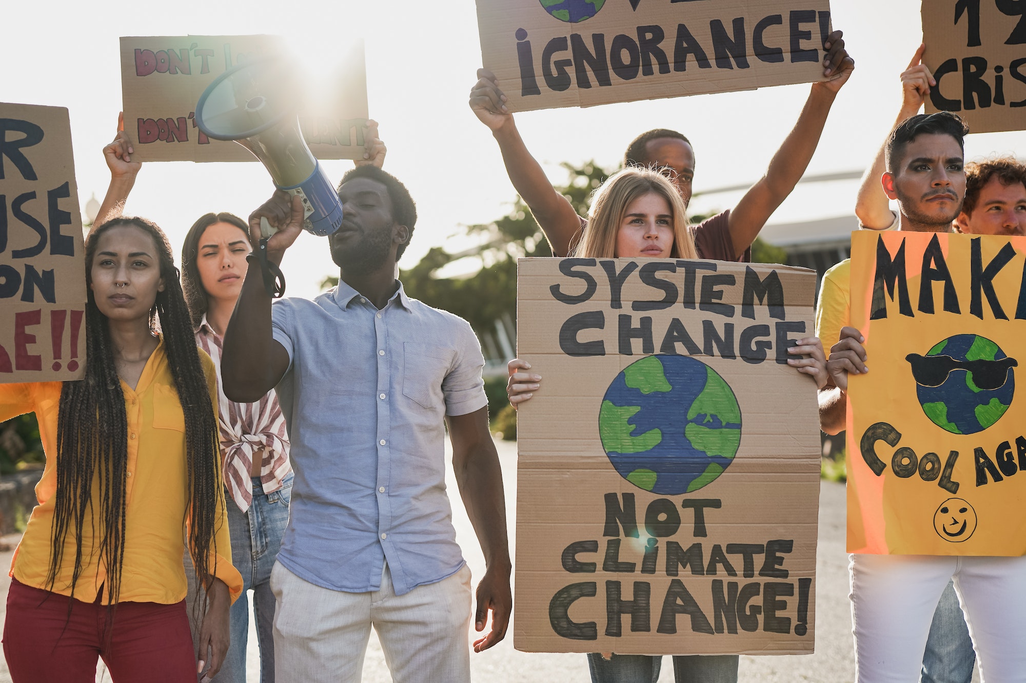 Young activist people with climate change banner on the street