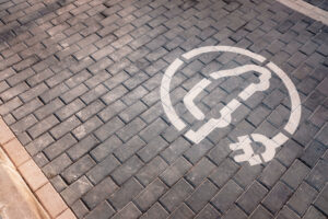 Electric recharging point for electric cars, EVs that pollute less, painted on the ground.